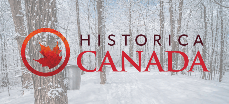 Historica Canada logo against a background image of maple trees in winter